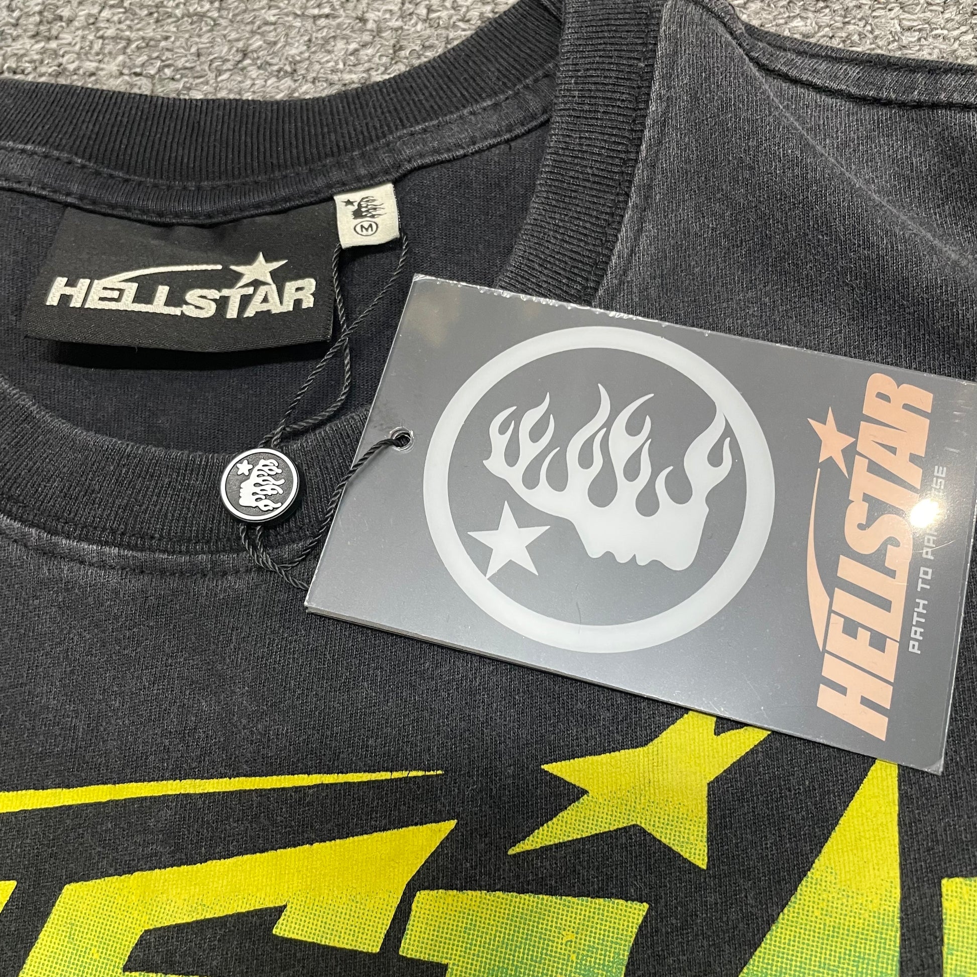 Close-up of ribbed crew neck and reinforced neckline stitching on Hellstar T-shirt
Hellstar branded neck label inside Santa Graphic washed black T-shirt
Size label inside Hellstar Santa Graphic T-shirt
Hellstar branded hang tag attached to Santa Graphic black T-shirt
