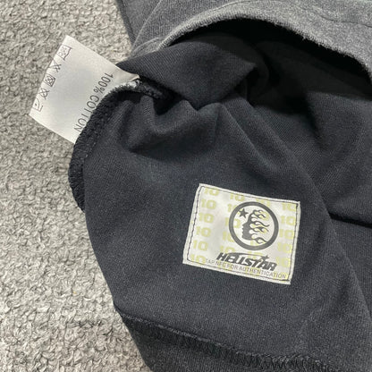 Close-up of bottom hem stitching on Hellstar washed black T-shirt
Fabric composition and care label inside Hellstar Santa Graphic T-shirt
NFC tag detail on Hellstar Santa Graphic washed black T-shirt