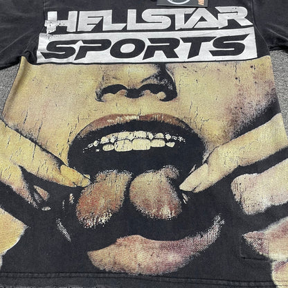 Oversized Hellstar Sports logo and mouth graphic on washed black T-shirt
Distressed Hellstar Sports lettering above a large face and mouth graphic
Close-up of white Hellstar Sports logo print on washed black T-shirt
Close-up of oversized face artwork on Hellstar Sports graphic T-shirt
Close-up of large mouth and tongue graphic on Hellstar Sports T-shirt
Detailed view of teeth lips and tongue artwork on Hellstar Sports T-shirt
Close-up of hand and finger details surrounding the mouth graphic
