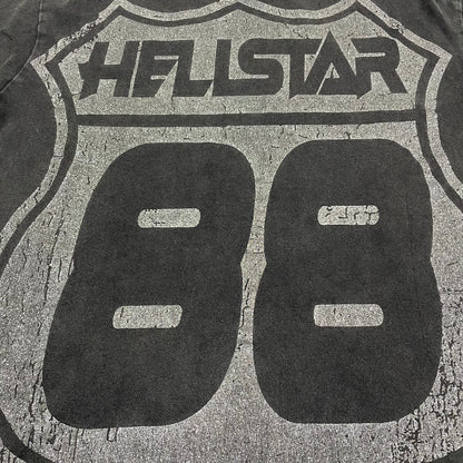 Oversized Hellstar Sports logo and mouth graphic on washed black T-shirt
Distressed Hellstar Sports lettering above a large face and mouth graphic
Close-up of white Hellstar Sports logo print on washed black T-shirt
Close-up of oversized face artwork on Hellstar Sports graphic T-shirt
Close-up of large mouth and tongue graphic on Hellstar Sports T-shirt
Detailed view of teeth lips and tongue artwork on Hellstar Sports T-shirt
Close-up of hand and finger details surrounding the mouth graphic

