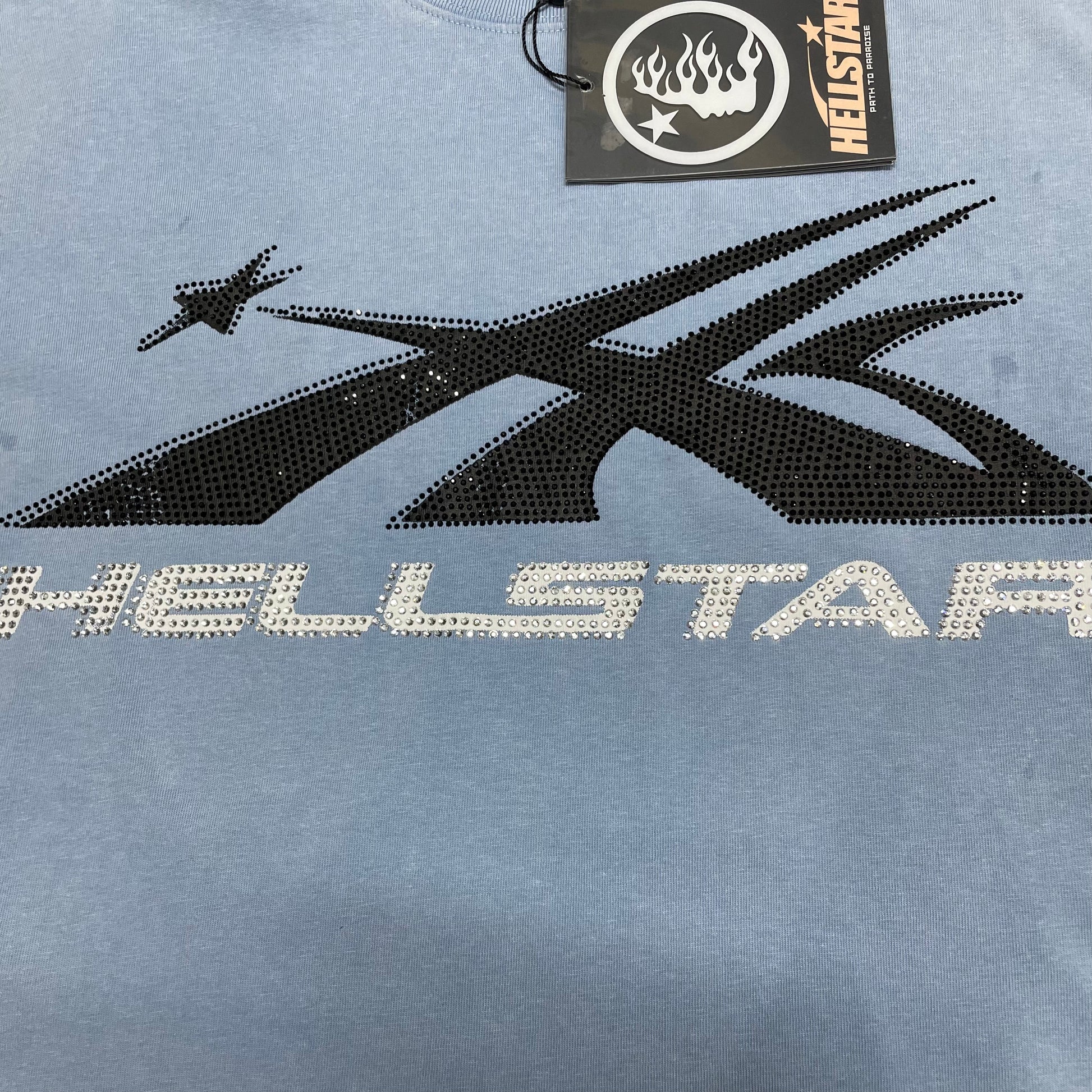 Full Hellstar Sports Core rhinestone logo on washed blue T-shirt
Athletic Hellstar Sports Core logo with black and clear rhinestone detailing
Close-up of Hellstar Sports Core logo on washed blue T-shirt
Close-up of black rhinestones forming the Hellstar Sports Core graphic
Close-up of clear rhinestones forming the Hellstar chest lettering