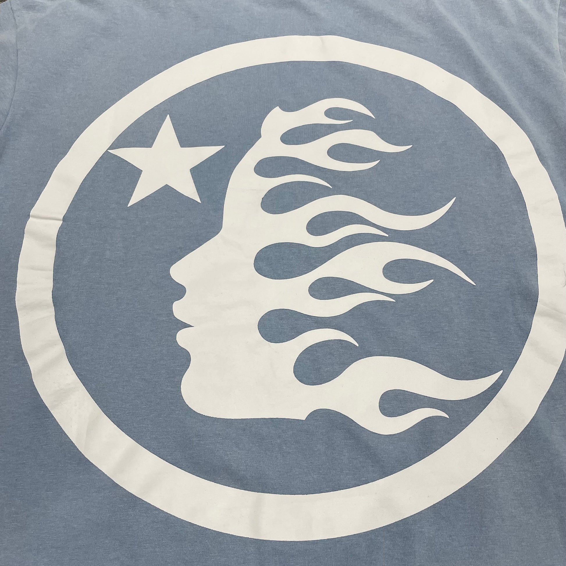 Full back graphic detail on Hellstar Sports Core blue T-shirt
Detailed view of rhinestone placement and Sports Core logo construction
Vintage acid-wash texture on Hellstar light blue T-shirt