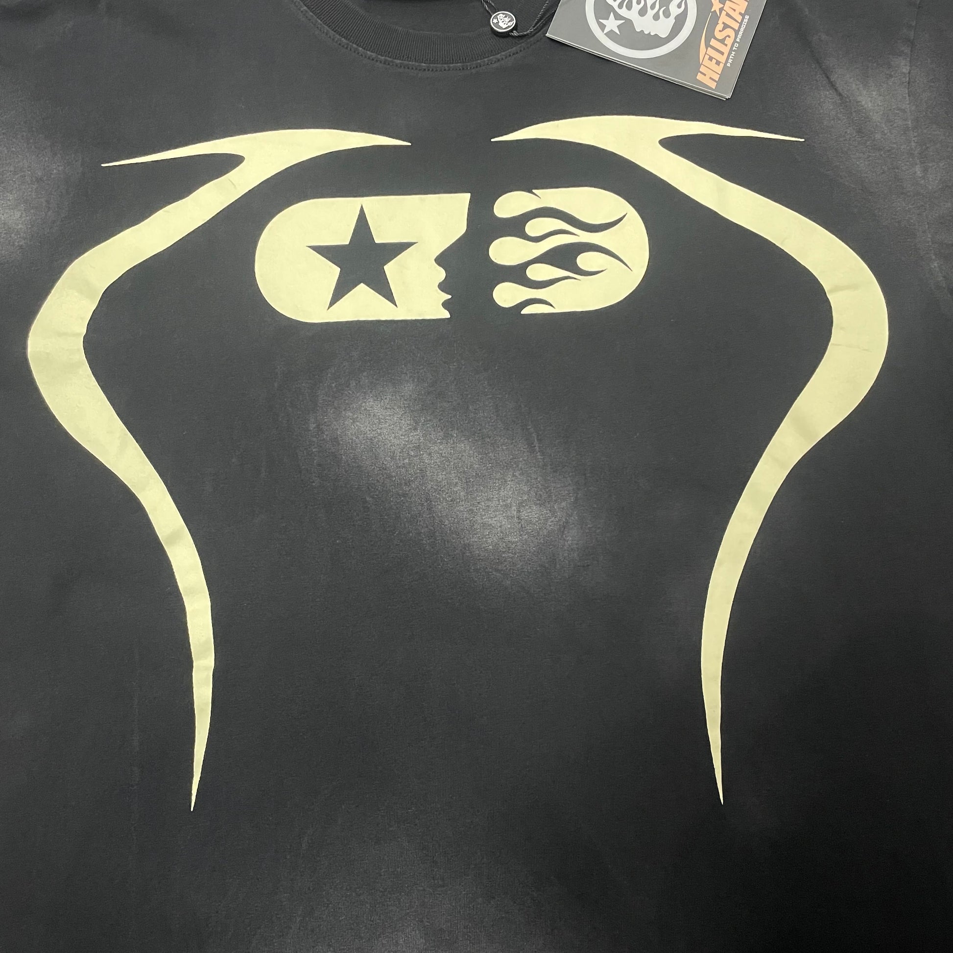 Oversized cream fist-bump graphic on Hellstar washed black T-shirt
Symmetrical fist-bump artwork with star and skeletal-hand details on black T-shirt
Close-up of cream fist-bump graphic on Hellstar washed black T-shirt
Close-up of touching fists at the center of Hellstar graphic T-shirt
