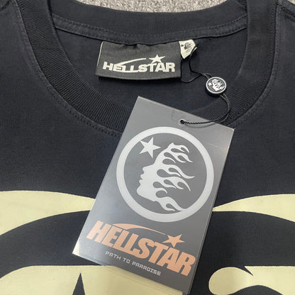 Close-up of ribbed crew neck and neckline stitching on Hellstar T-shirt
Hellstar branded neck label inside Fist Bump graphic T-shirt
Size label inside Hellstar Fist Bump washed black T-shirt
Hellstar branded hang tag attached to Fist Bump graphic T-shirt
Close-up of Hellstar flame-face hang tag and attachment detail
