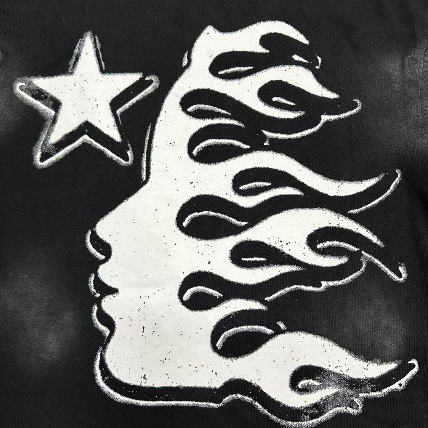 Distressed Hellstar lettering above the oversized eyeball graphic
Close-up of Hellstar flame-face icon inside the eyeball graphic

