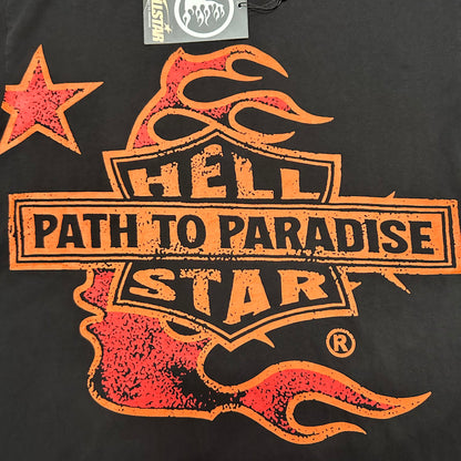 Oversized Hellstar Path To Paradise shield and flame graphic on black T-shirt
Hellstar Path To Paradise shield logo with orange-red flames and star graphic
Close-up of Hellstar Path To Paradise flame graphic on washed black T-shirt
Close-up of distressed Hellstar lettering inside the front shield graphic
Close-up of Path To Paradise text on Hellstar graphic T-shirt
Close-up of orange and red flame details on Hellstar black T-shirt