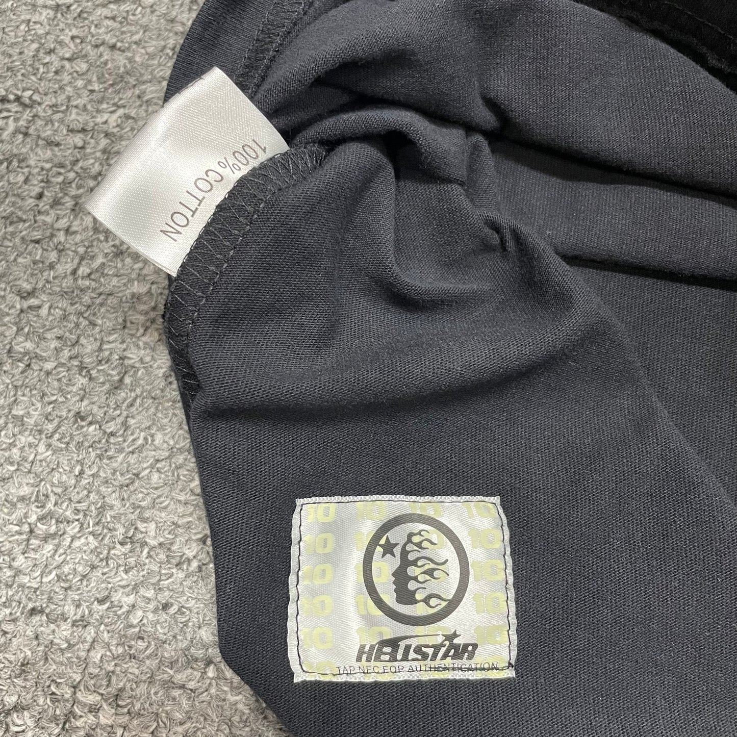 Close-up of bottom hem stitching on Hellstar sleeveless T-shirt
Fabric composition and care label inside Hellstar Inner Peace sleeveless T-shirt
NFC tag detail on Hellstar Inner Peace Skeleton sleeveless T-shirt