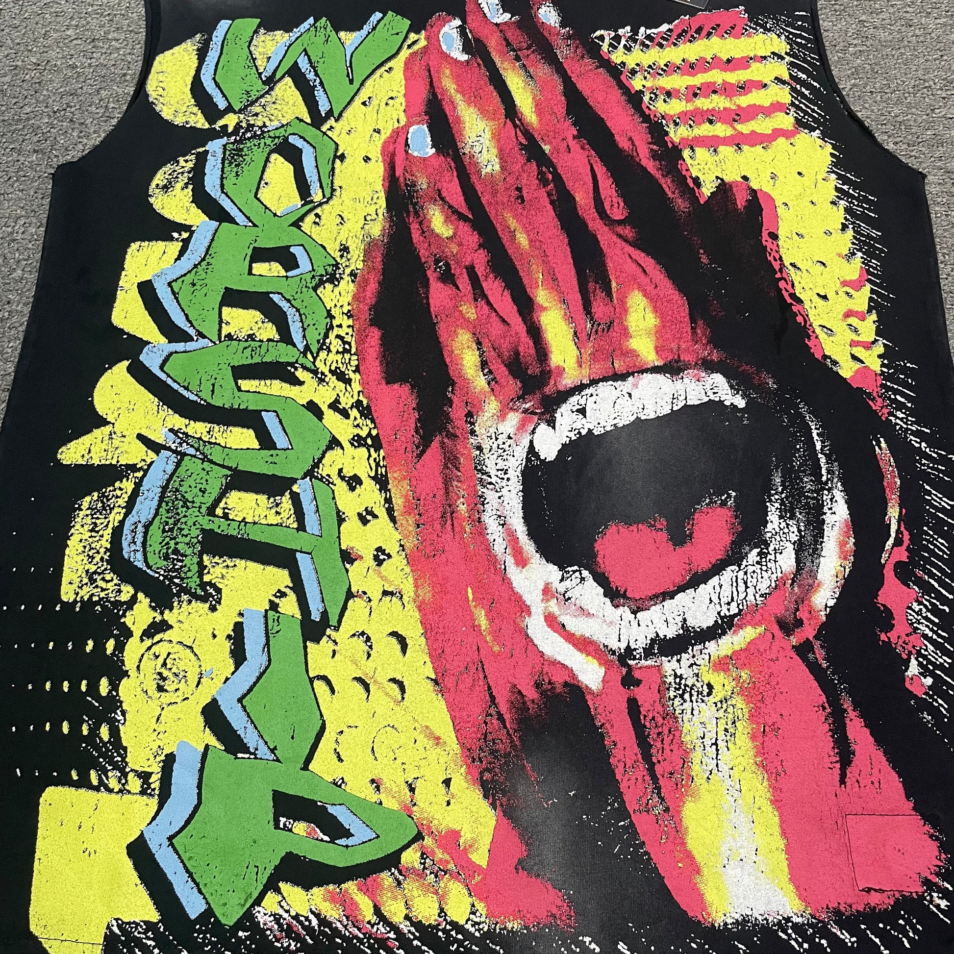 Oversized Worship Hands multicolor graphic on Hellstar sleeveless black T-shirt
Colorful Hellstar Worship artwork featuring red praying hands and an open mouth graphic
Close-up of green and blue Worship lettering on Hellstar graphic T-shirt
Detailed view of red praying hands artwork on Hellstar Worship T-shirt
Close-up of open mouth teeth and tongue graphic on Hellstar sleeveless T-shirt