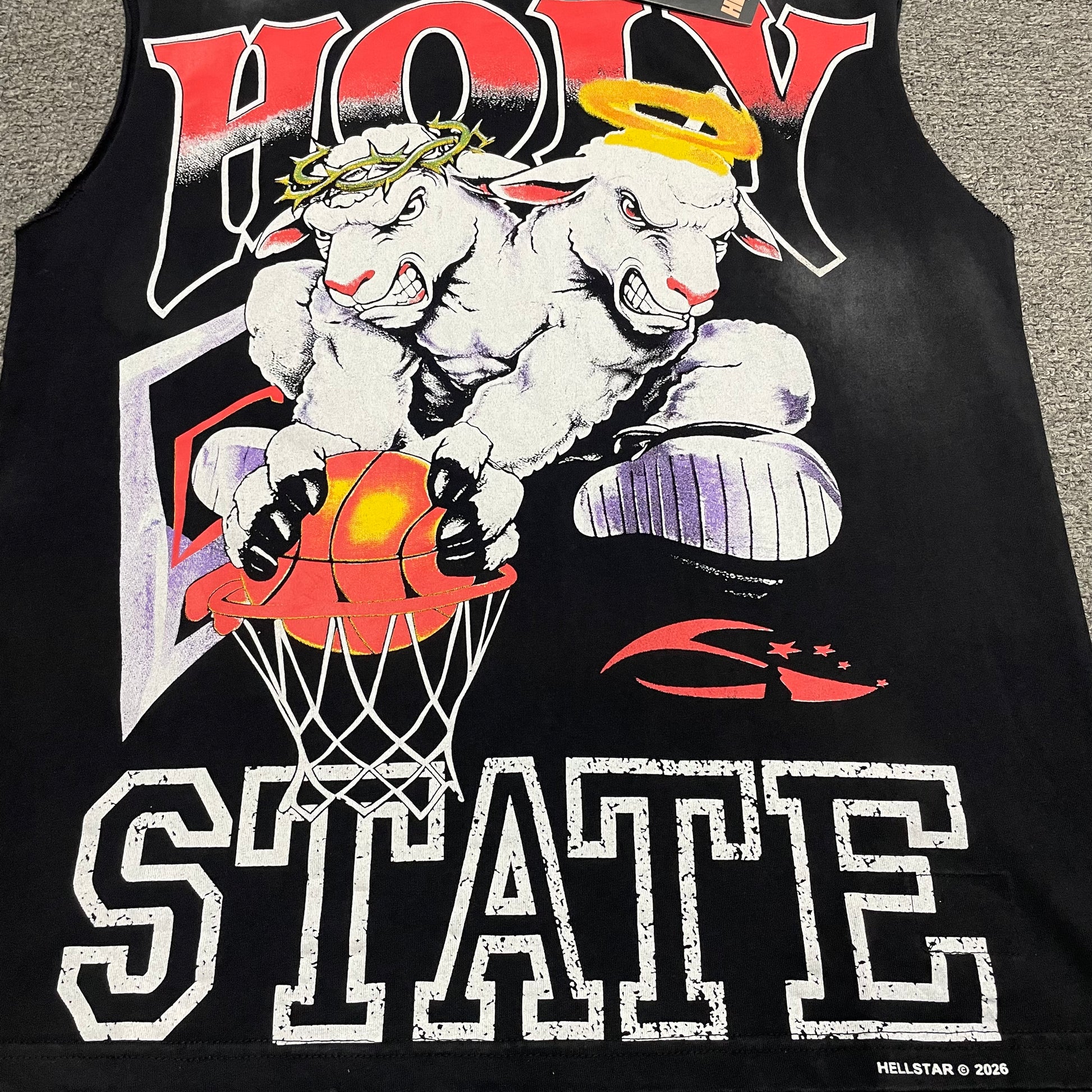 Hellstar Holy State two lambs basketball artwork with halo crown and varsity lettering
Hellstar 2 Lambs Holy State jumbo screen print texture and color detail
Hellstar Holy State halo and thorn crown lamb character print close-up
Hellstar Holy State distressed varsity lettering print close-up
Hellstar 2 Lambs basketball and hoop graphic print detail
Hellstar sleeveless T-shirt vintage black washed and faded fabric detail