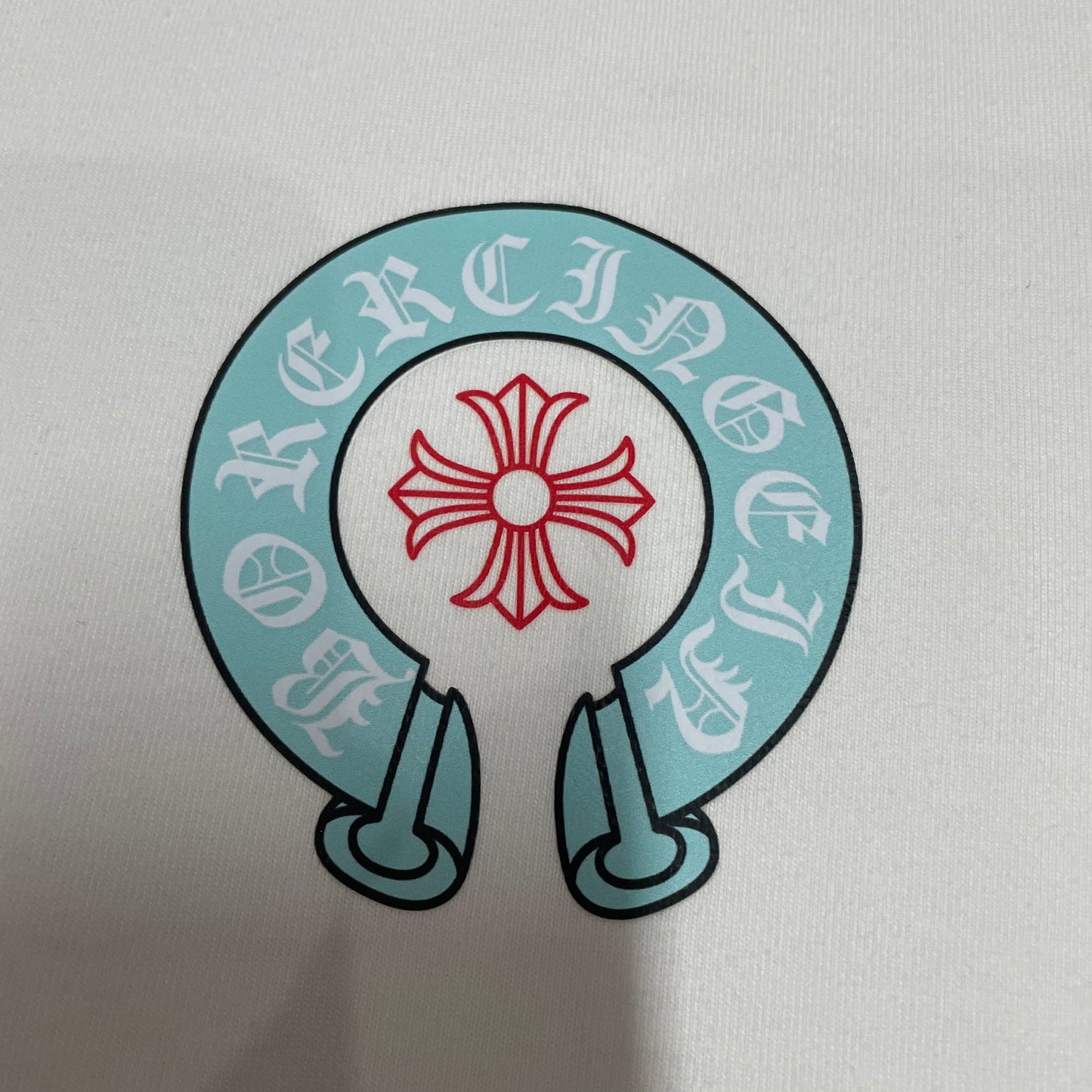 Chrome Hearts horseshoe cross chest logo print close up detail