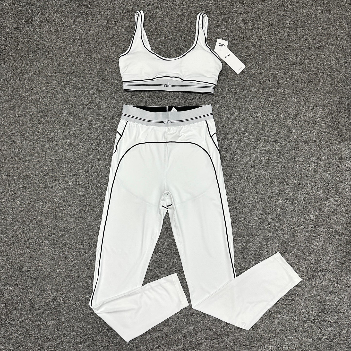 ALO Heart Throb Bra and High-Waist Legging Set in White Black front view