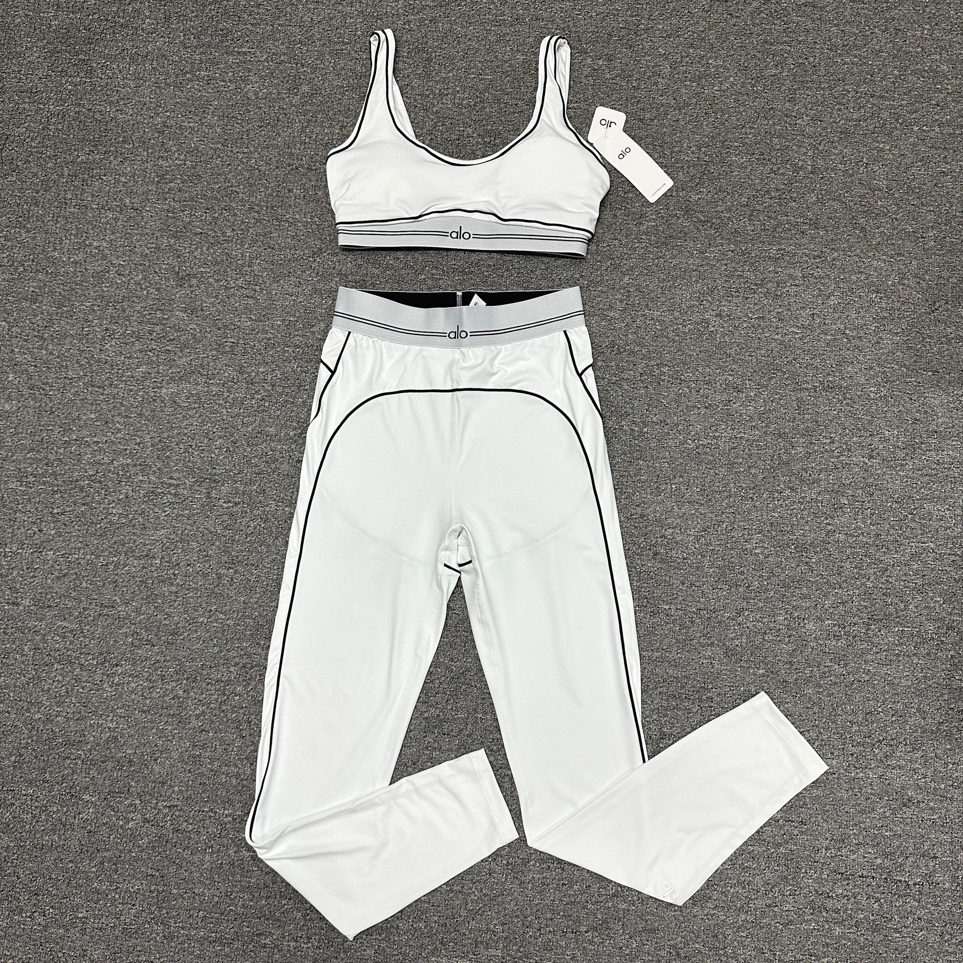 ALO Heart Throb Bra and High-Waist Legging Set in White Black front view