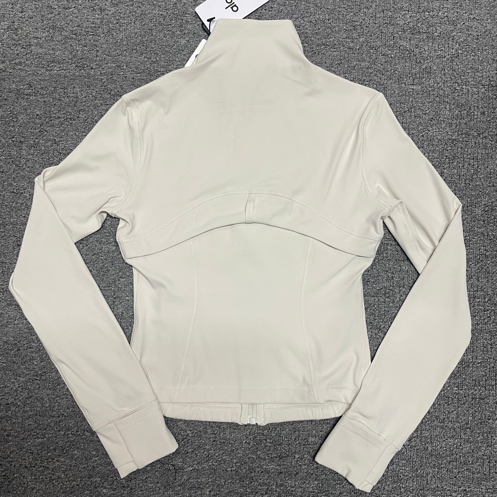 ALO Airbrush Corset Full Zip Jacket in Ivory back view showing the slim fitted silhouette