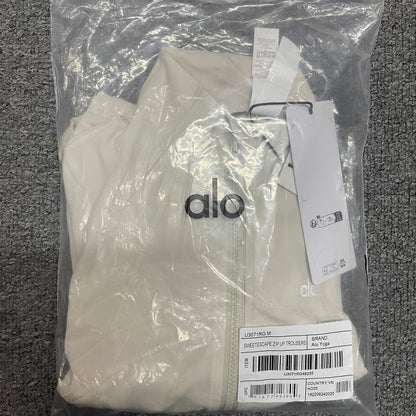 ALO Airbrush Ivory Corset Full Zip Jacket folded inside branded packaging bag