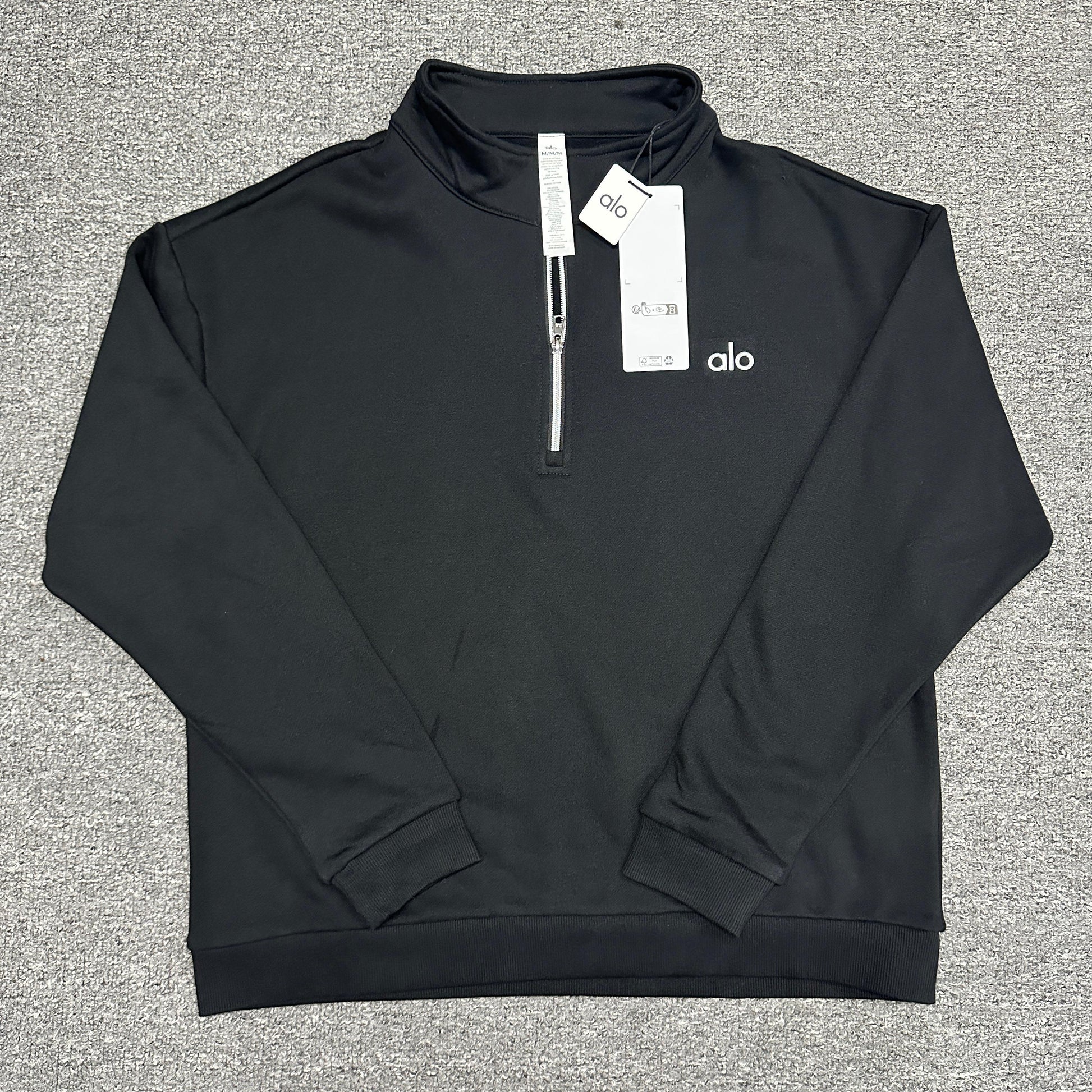 ALO Accolade 1/4 Zip Pullover in Black front view with embroidered chest logo