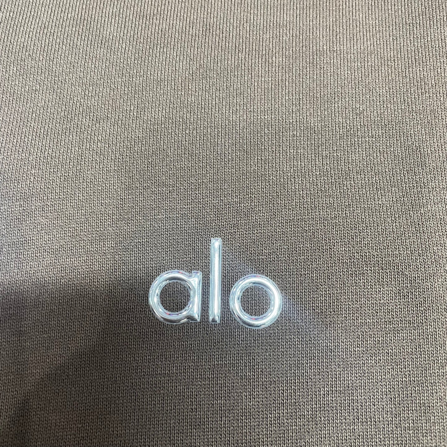 Embroidered ALO chest logo close-up on Espresso Accolade Hoodie