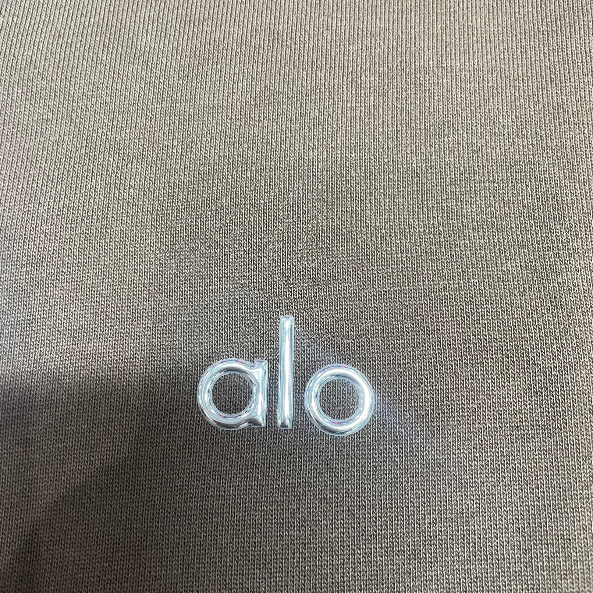 Embroidered ALO chest logo close-up on Espresso Accolade Hoodie