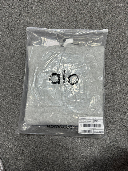 ALO Accolade Athletic Heather Grey hoodie folded inside branded zip packaging bag