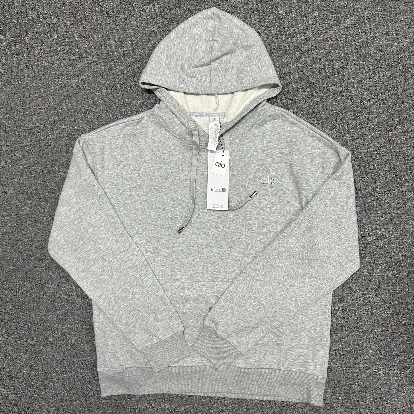 ALO Accolade Hoodie in Athletic Heather Grey front view with embroidered chest logo
