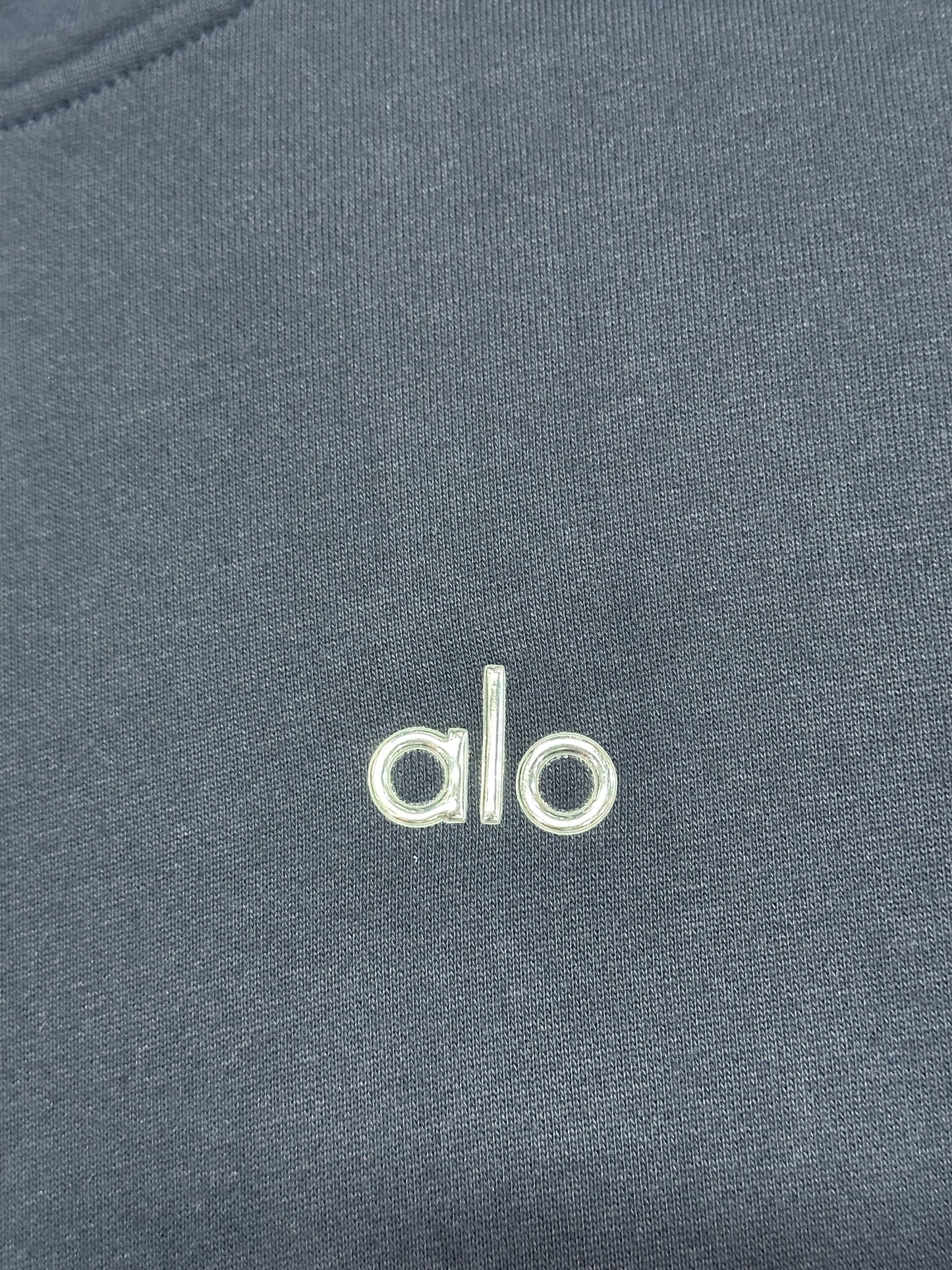 Embroidered ALO chest logo close-up on Navy Accolade Hoodie