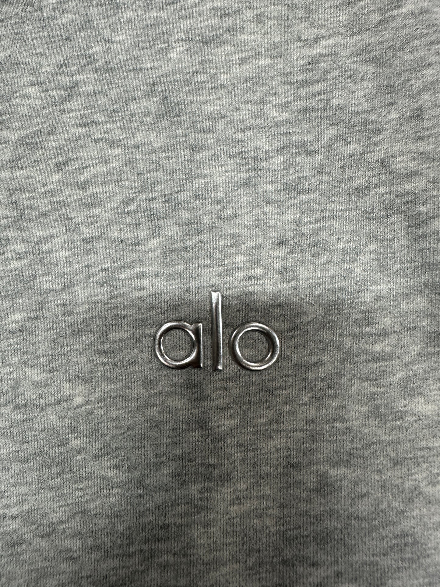 Embroidered ALO chest logo close-up on Athletic Heather Grey Accolade Hoodie