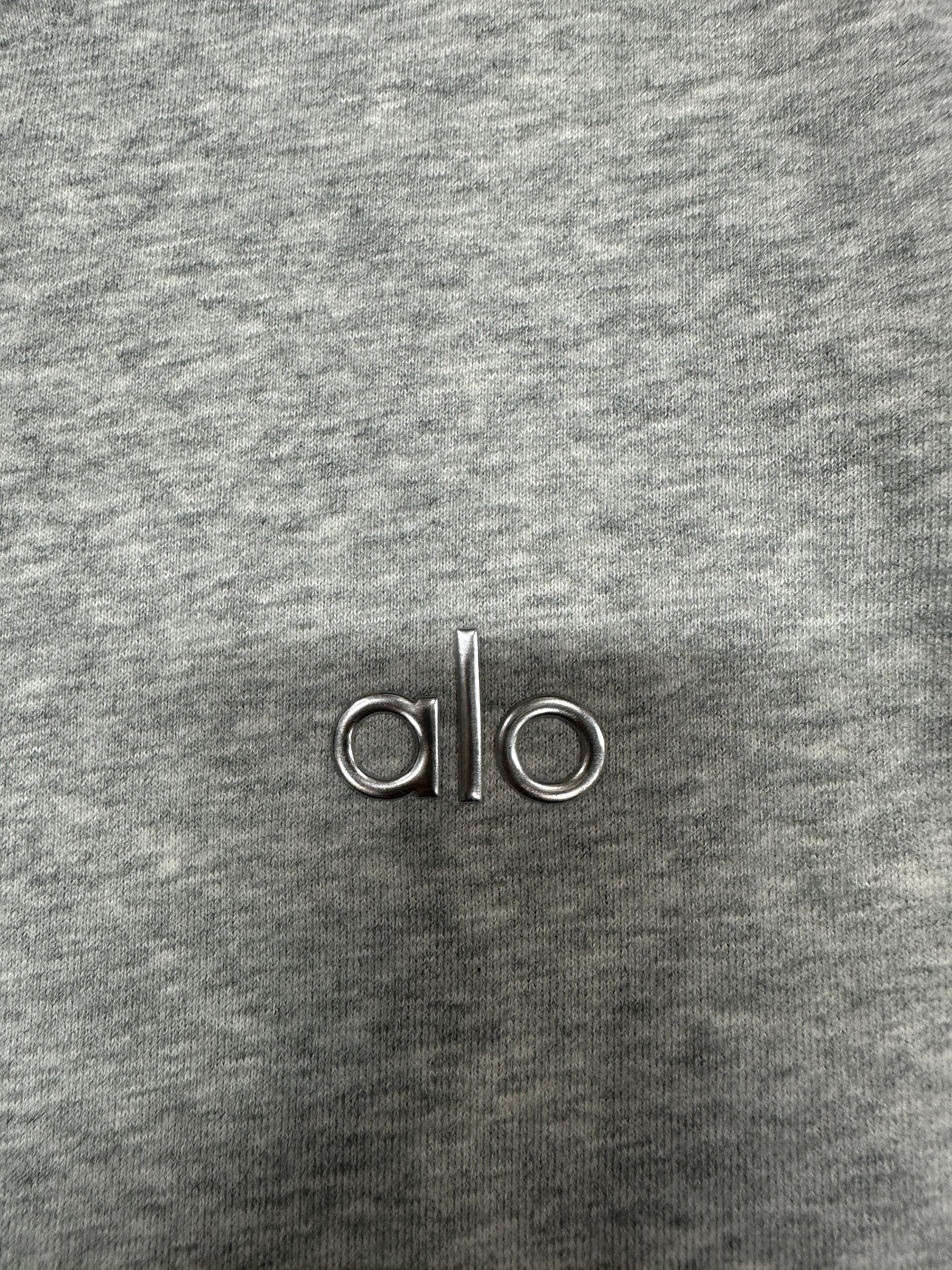 Embroidered ALO chest logo close-up on Athletic Heather Grey Accolade Hoodie