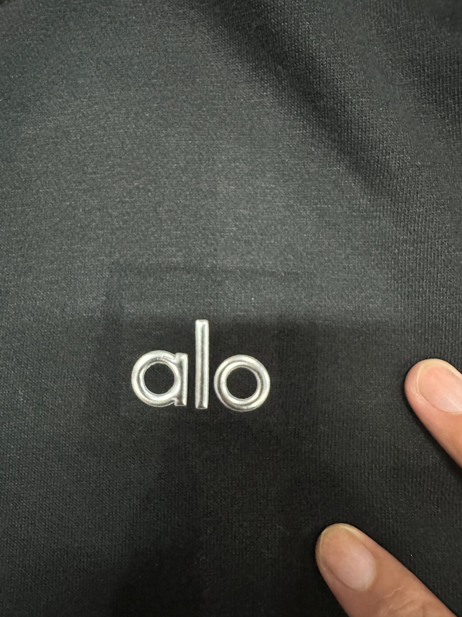 Embroidered ALO chest logo close-up on Black Accolade Hoodie