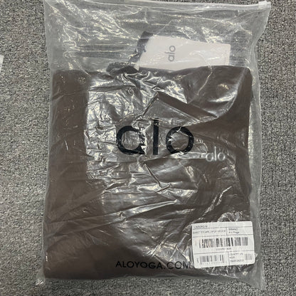 ALO Accolade Espresso hoodie folded inside branded zip packaging bag