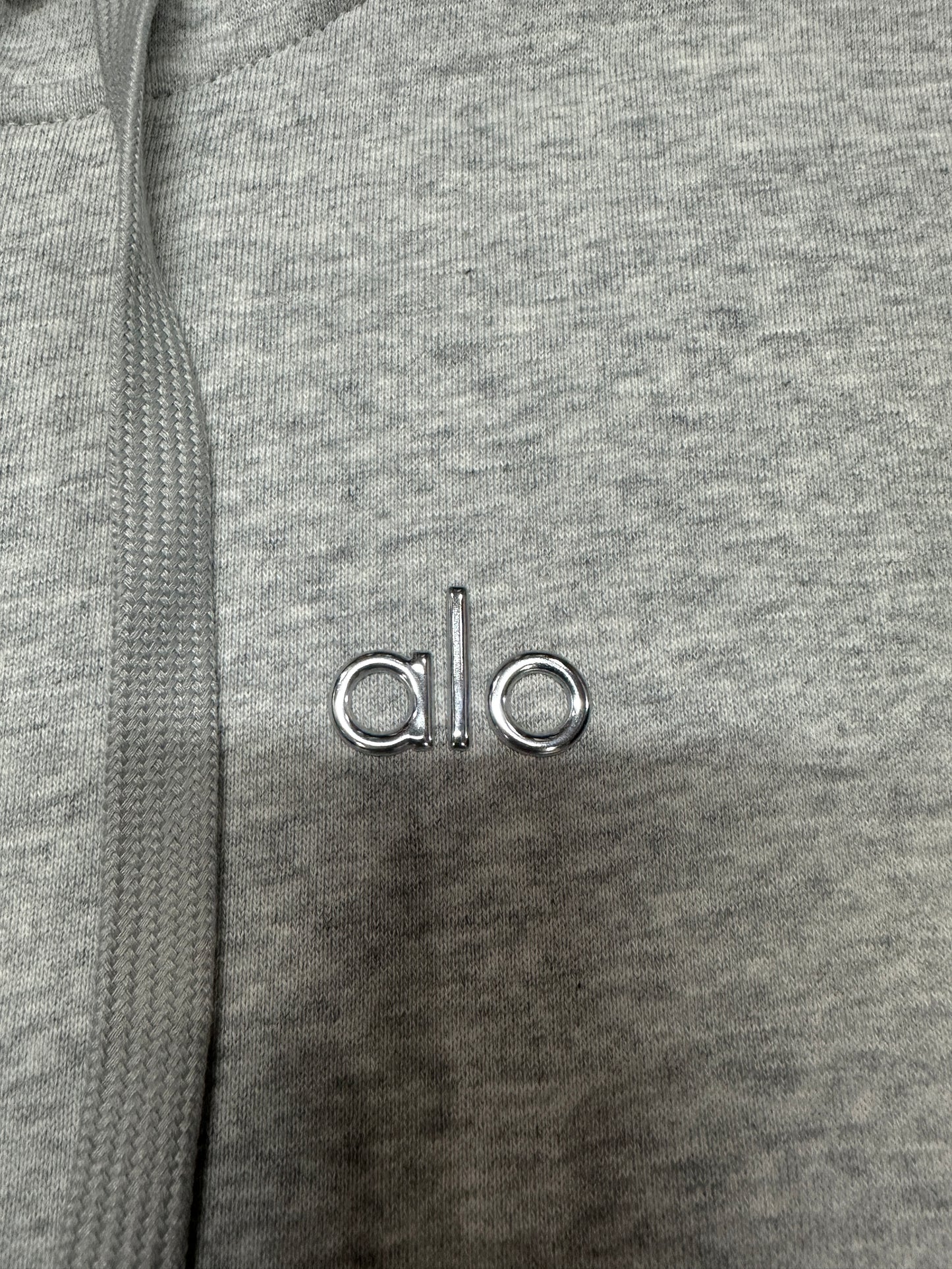 ALO embroidered chest logo placement on Athletic Heather Grey Accolade hoodie
Minimal embroidered ALO chest logo on Athletic Heather Grey full zip hoodie