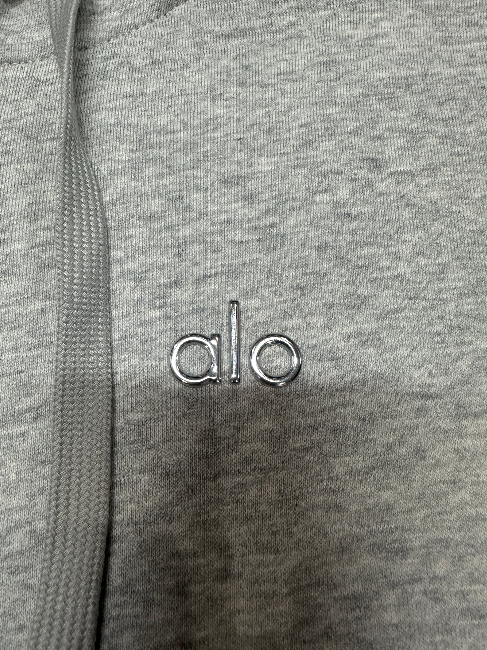 ALO embroidered chest logo placement on Athletic Heather Grey Accolade hoodie
Minimal embroidered ALO chest logo on Athletic Heather Grey full zip hoodie