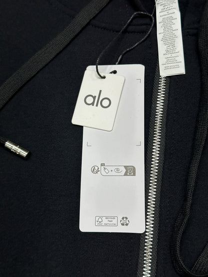 ALO Accolade Black full zip hoodie neckline, hood and drawstring construction detail
ALO Accolade Black full zip hoodie neck label close-up
ALO Accolade Black full zip hoodie size label detail
ALO Accolade Black full zip hoodie with branded retail hangtags