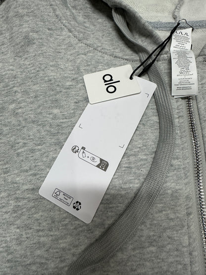 ALO Accolade Athletic Heather Grey hood, neckline and drawstring construction detail
ALO Accolade Athletic Heather Grey full zip hoodie neck label close-up
ALO Accolade Athletic Heather Grey full zip hoodie size label detail
ALO Accolade Athletic Heather Grey full zip hoodie with branded retail hangtags