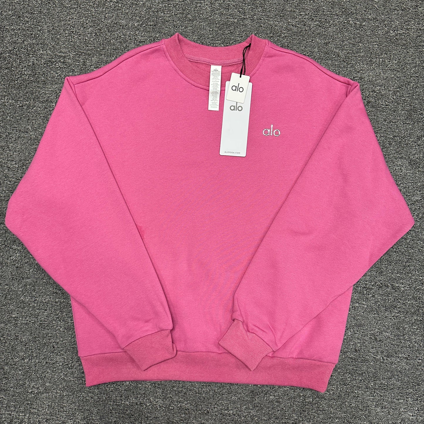 ALO Accolade Crew Neck Pullover in Paradise Pink front view with silver chest logo