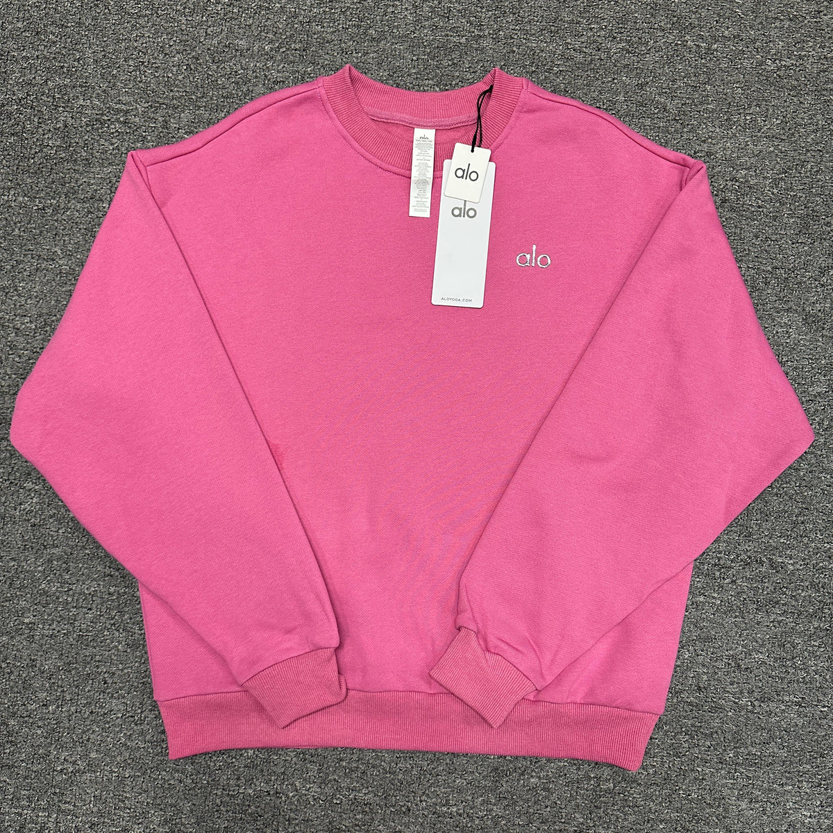ALO Accolade Crew Neck Pullover in Paradise Pink front view with silver chest logo