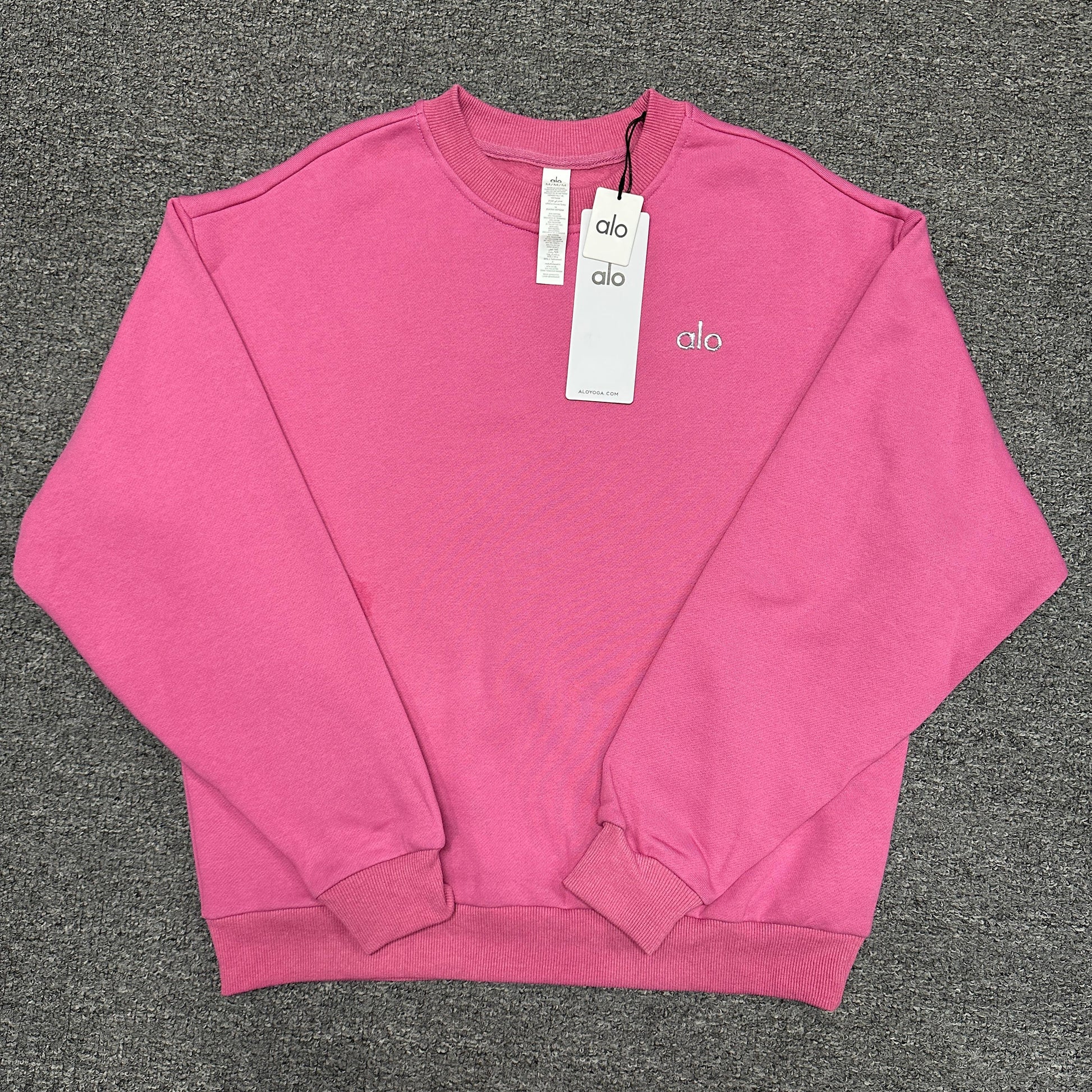 ALO Accolade Crew Neck Pullover in Paradise Pink front view with silver chest logo
