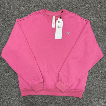 ALO Accolade Crew Neck Pullover in Paradise Pink front view with silver chest logo