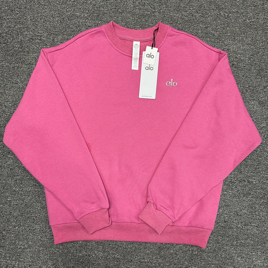 ALO Accolade Crew Neck Pullover in Paradise Pink front view with silver chest logo