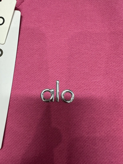 Silver ALO chest logo close-up on Paradise Pink Accolade Crew Neck Pullover