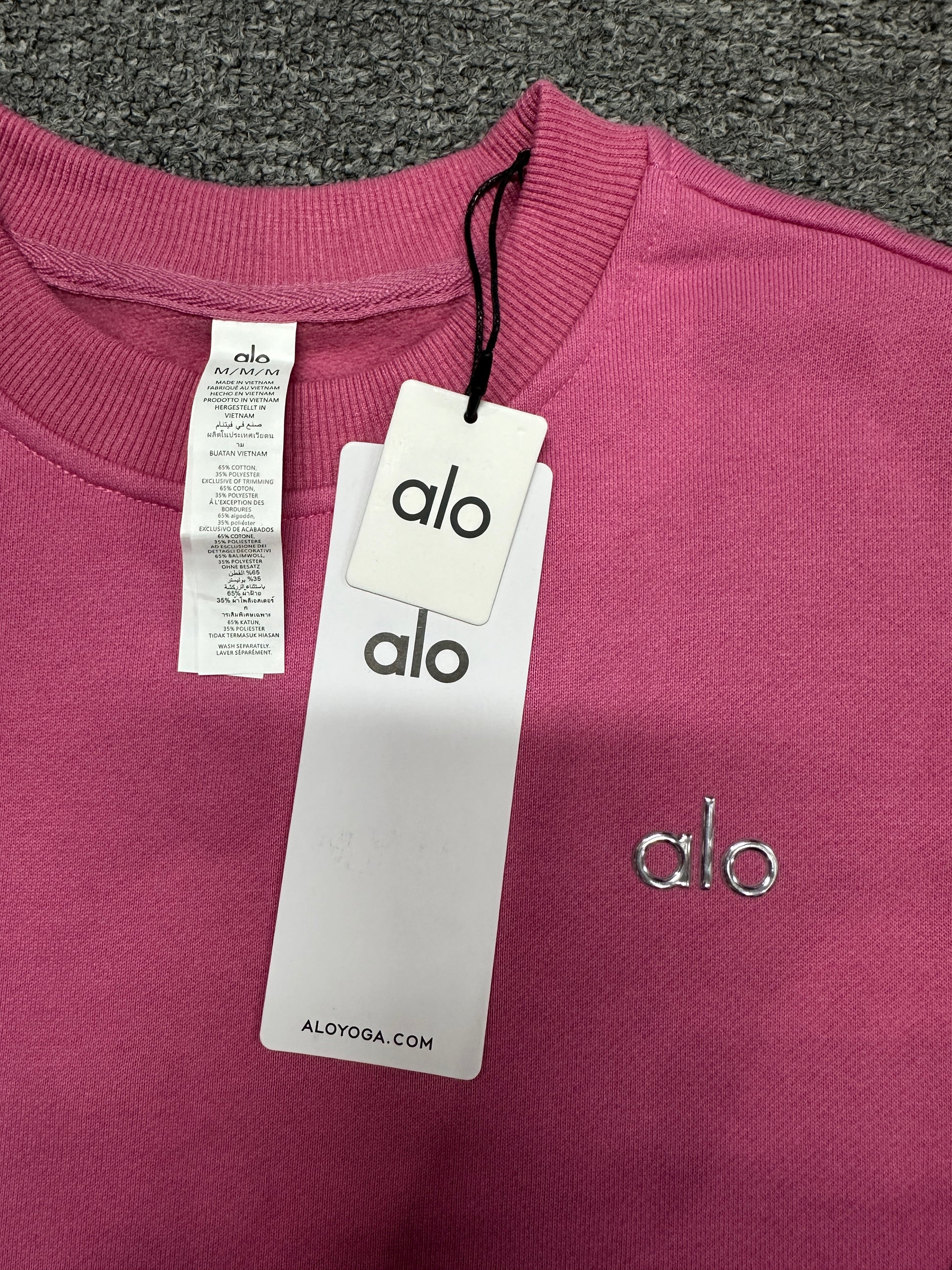 ALO Accolade Paradise Pink pullover ribbed crew neckline and stitching detail
ALO Accolade Paradise Pink crewneck neck label and size information detail
ALO Accolade Paradise Pink crewneck sweatshirt with branded retail hangtags
ALO Accolade Paradise Pink pullover care label and fabric information detail