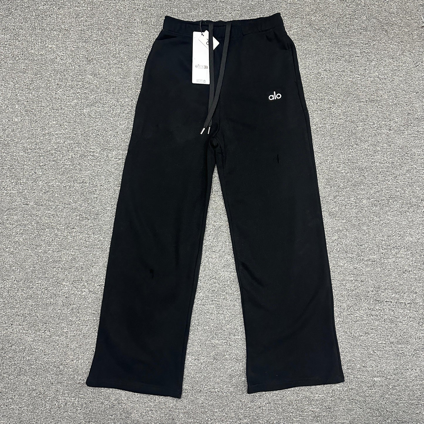 ALO Accolade Straight Leg Sweatpant in Black front view with chrome logo detail