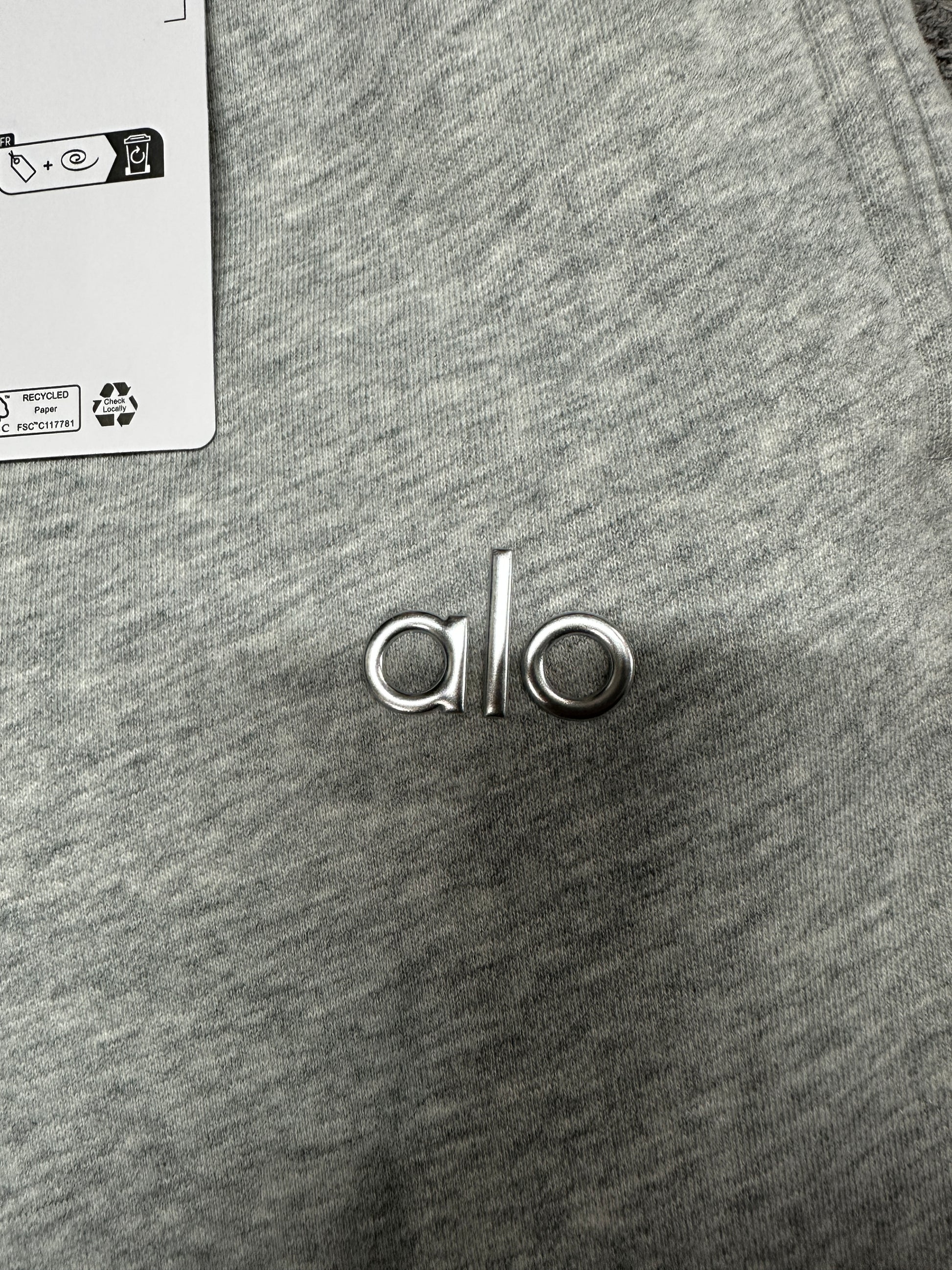 Chrome ALO logo close-up on Athletic Heather Grey Accolade Straight Leg Sweatpant