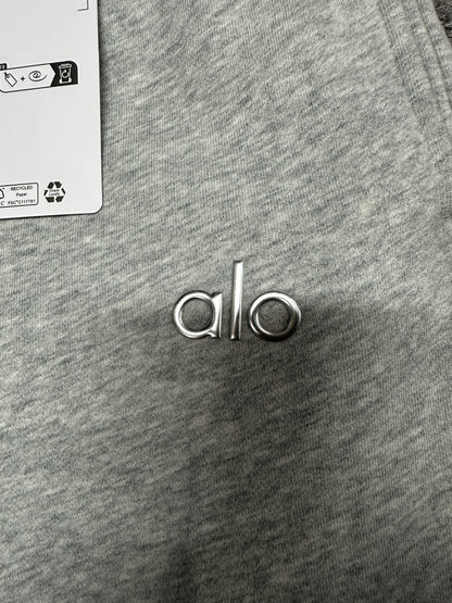 Chrome ALO logo close-up on Athletic Heather Grey Accolade Straight Leg Sweatpant