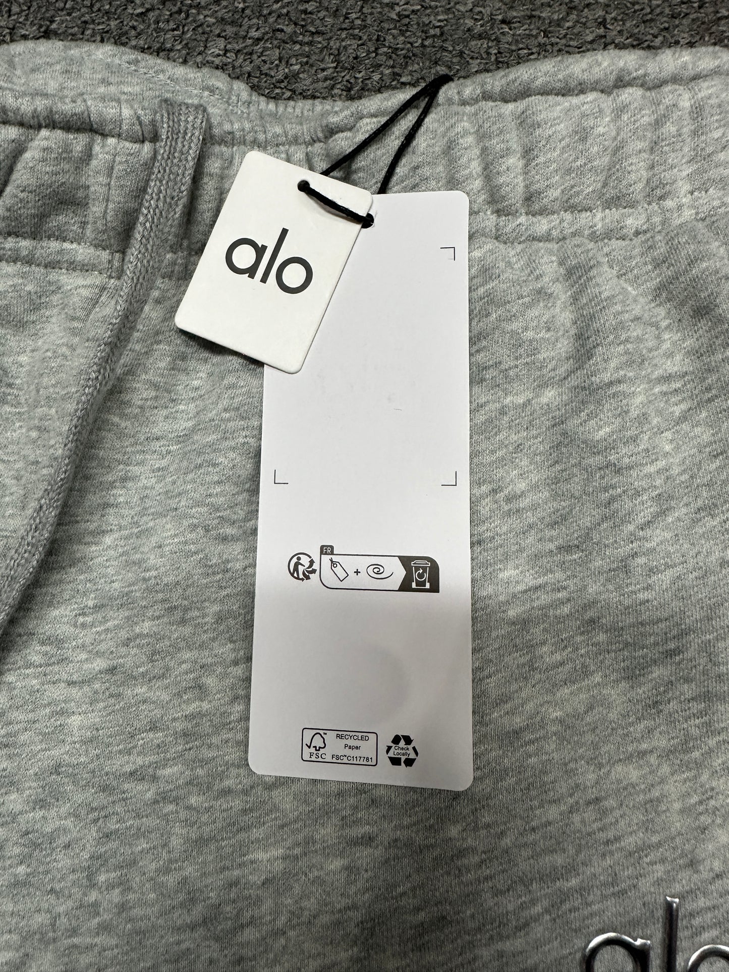 ALO Accolade Athletic Heather Grey elastic waistband and drawstring construction detail
ALO Accolade Athletic Heather Grey sweatpant inner waist label and size detail
ALO Accolade Athletic Heather Grey straight leg sweatpant with branded retail hangtags
