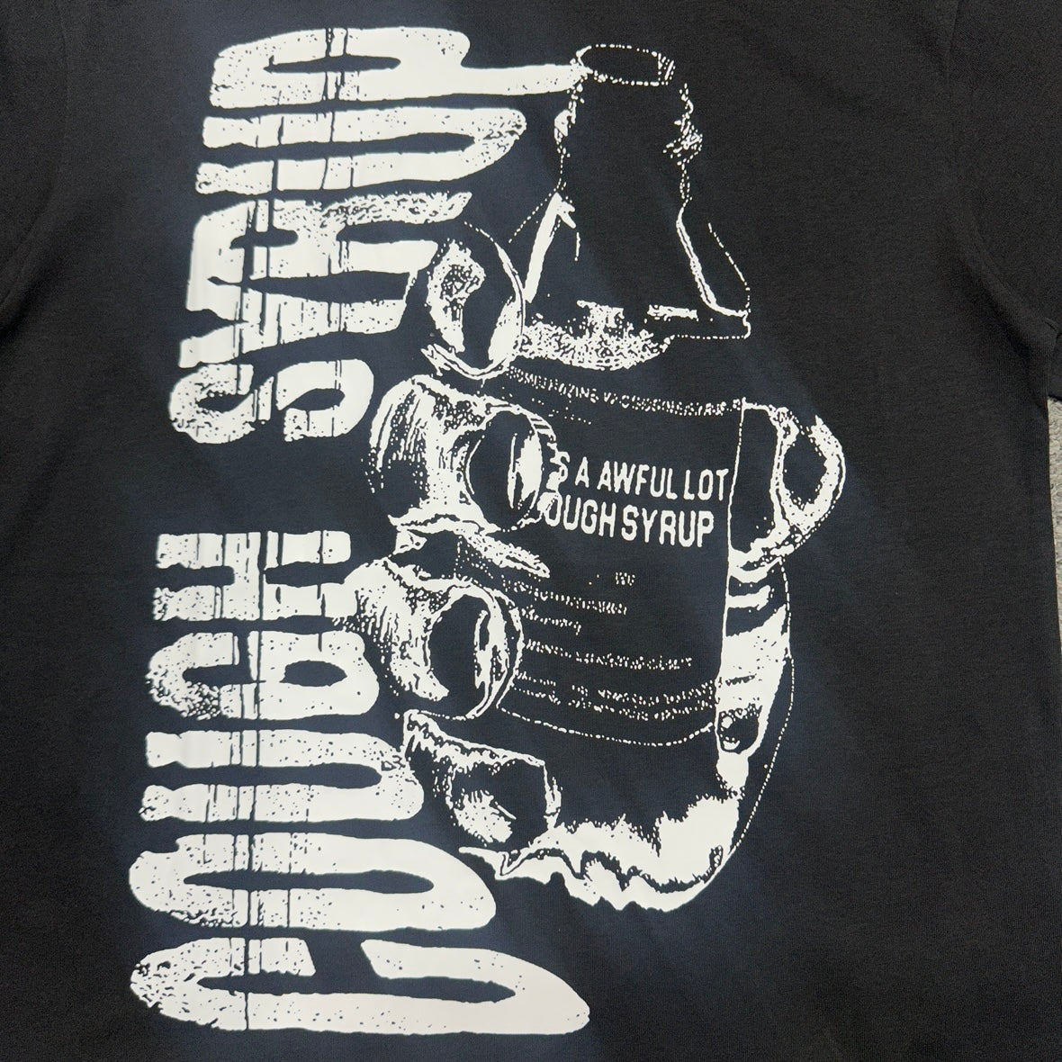 The "Hand Holding Bottle" graphic t-shirt