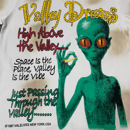 Vale Forever Valley Dreams Alien Tee full front graphic print and typography
Valley Dreams Alien T-Shirt green alien artwork with High Above the Valley slogan
Valley Dreams Alien Rhinestone Tee lettering and graphic print close-up
Valley Dreams Graphic Tee green alien face and orange eye print detail
Valley Dreams T-Shirt yellow rhinestone logo lettering close-up
Vale Forever Alien Tee distressed off-white vintage wash detail