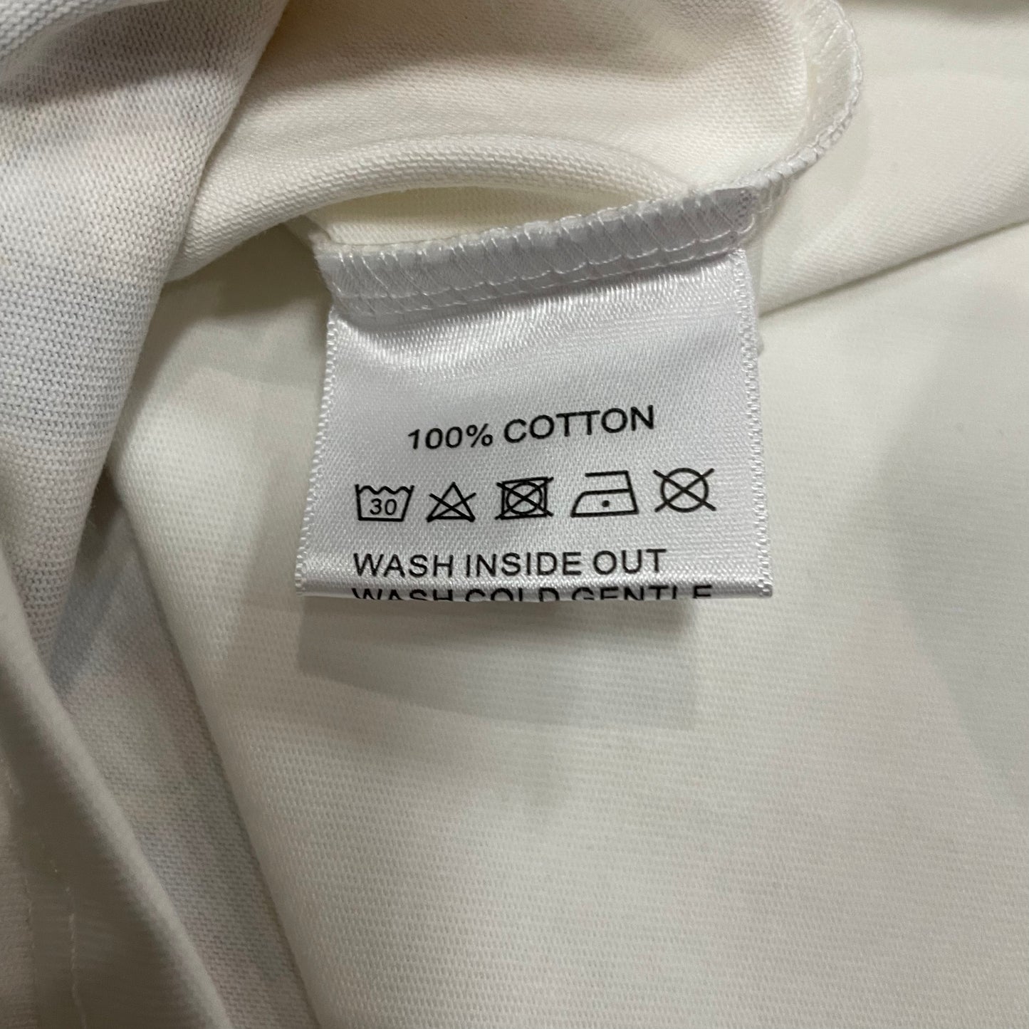 Vale Forever Badu Tee double stitched bottom hem detail
Vale Forever Badu Tee wash care label close-up