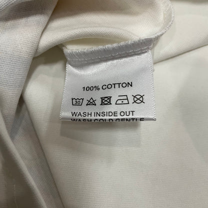 Vale Forever Badu Tee double stitched bottom hem detail
Vale Forever Badu Tee wash care label close-up