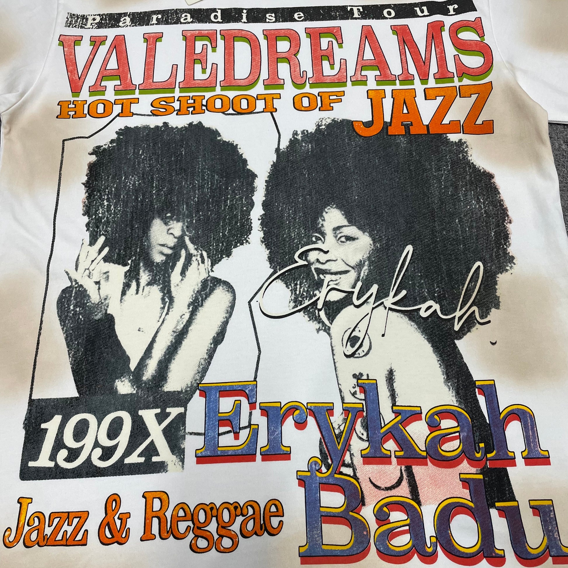 Vale Forever Badu Tee full Erykah Badu front graphic print
Vale Forever Badu Tee with Erykah Badu portraits and jazz inspired graphics
Vale Forever Badu Tee vintage tour poster graphic detail
Erykah Badu dual portrait print detail on Vale Forever cream tee
Vale Dreams Jazz and Reggae multicolor lettering print detail
Vale Forever Badu Tee cream distressed vintage wash detail