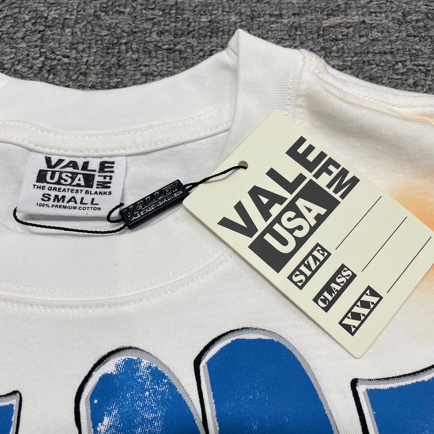 Vale Forever Americas Dream Tee crew neck stitching detail
Vale Forever Americas Dream Bling Tee branded neck label
Vale Forever Americas Dream Bling Tee size label close-up
Vale Forever Americas Dream Bling Tee branded hang tag detail
