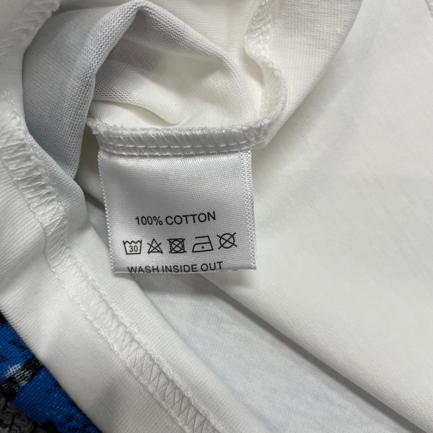 Vale Forever Fallen Bling Tee double stitched bottom hem detail
Vale Forever Fallen Bling Tee wash care label close-up